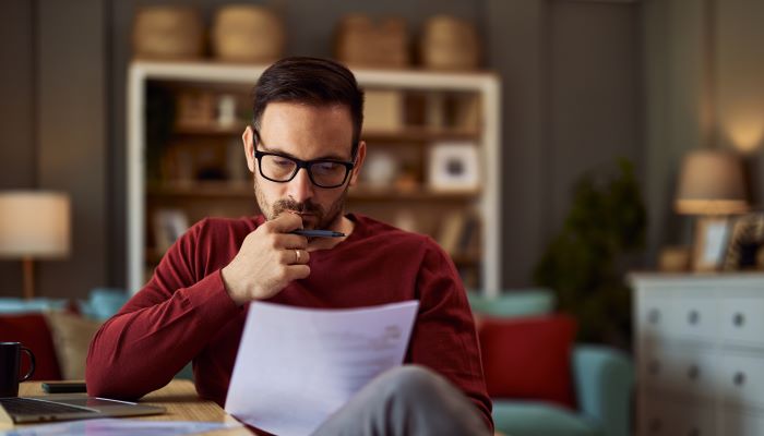 Man checking text with a red pen